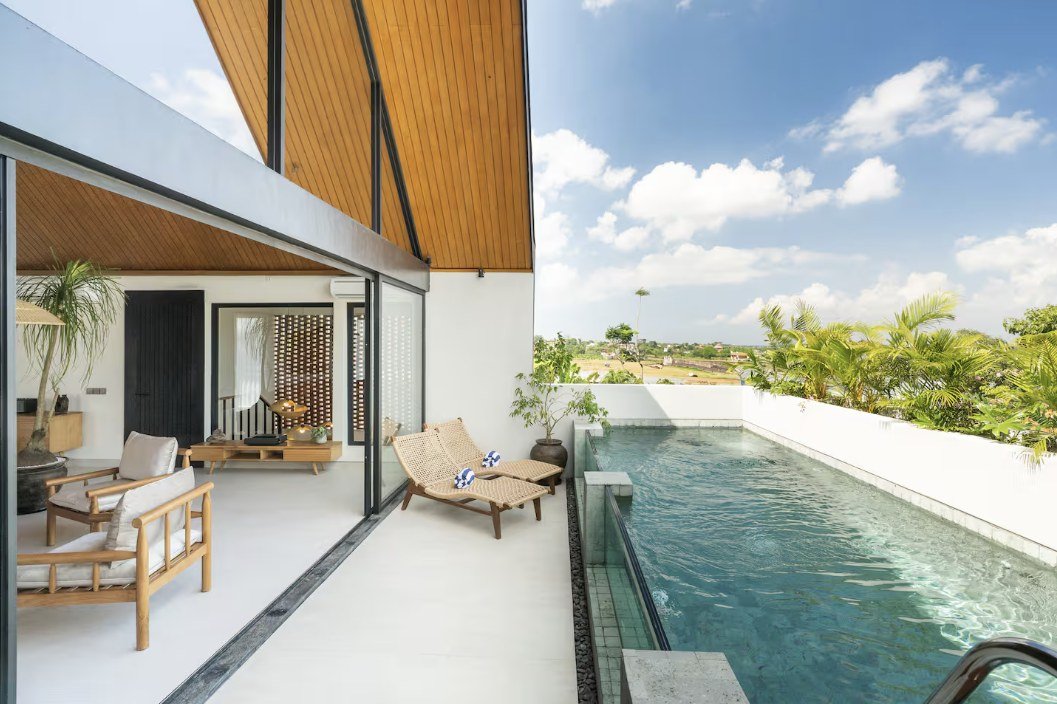 Rooftop glass-edge pool with sun loungers — Makia Properties, Canggu Bali