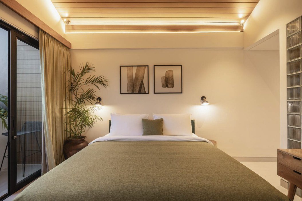 Makia Loft bedroom at dusk with sliding doors to the terrace